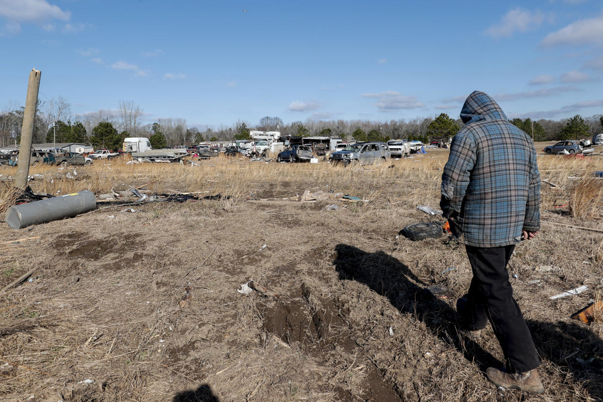 David Hollon walks his property looking for personal items as they recover from a tornado that ripped through Central Alabama earlier this week along County Road 140 where loss of life occurred Saturday, Jan. 14, 2023, in White City, Autauga County, Ala. (AP Photo/Butch Dill)