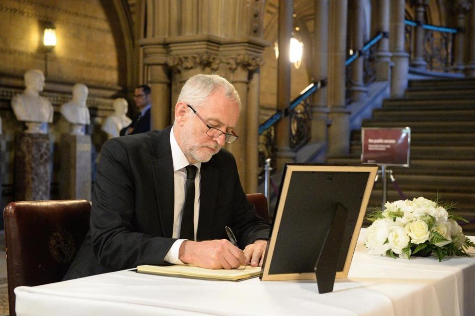 Labour leader Jeremy Corbyn signs a book of condolence at Manchester Town Hall (PA)