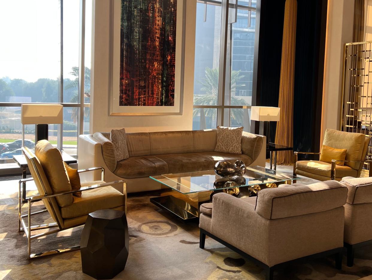 Cream couches with a rug and an art in an upscale hotel in Dubai
