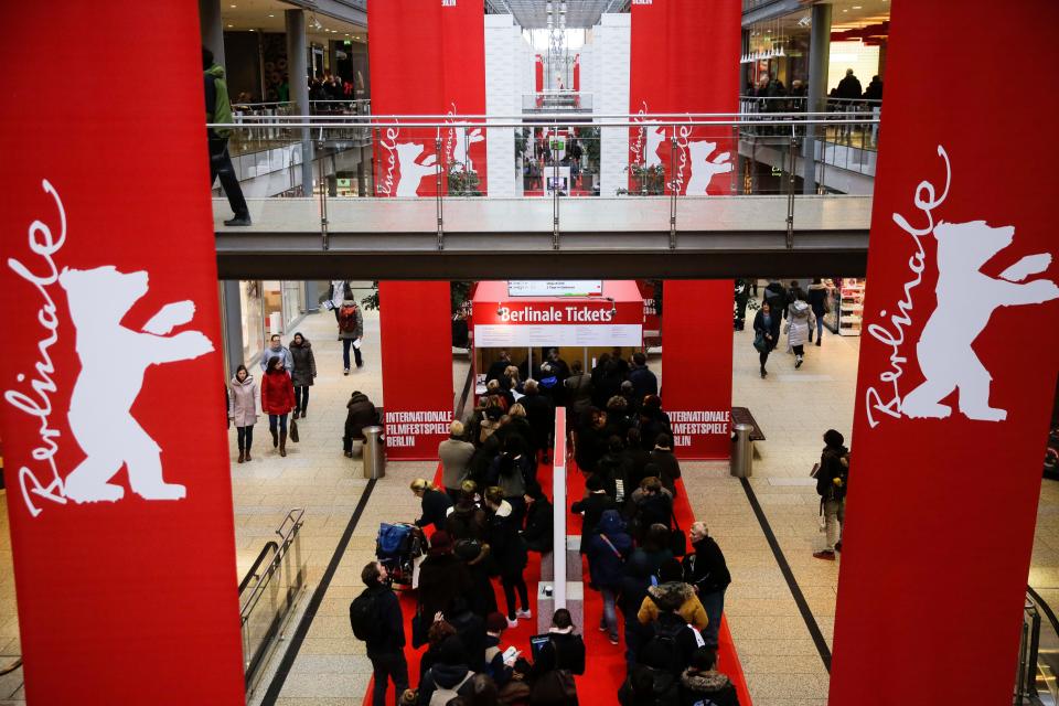 People line up in front of a ticket counter for tickets of the International Film Festival Berlinale inside a shopping mall at the Potsdamer Platz square in Berlin, Feb. 12, 2018.