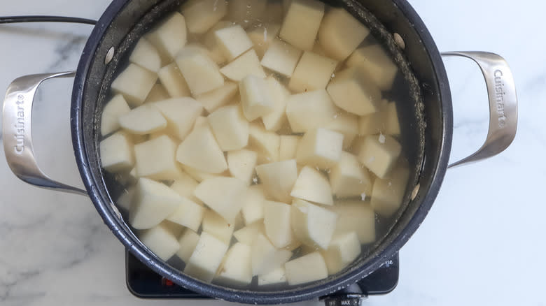 cubed potatoes cooking in pot