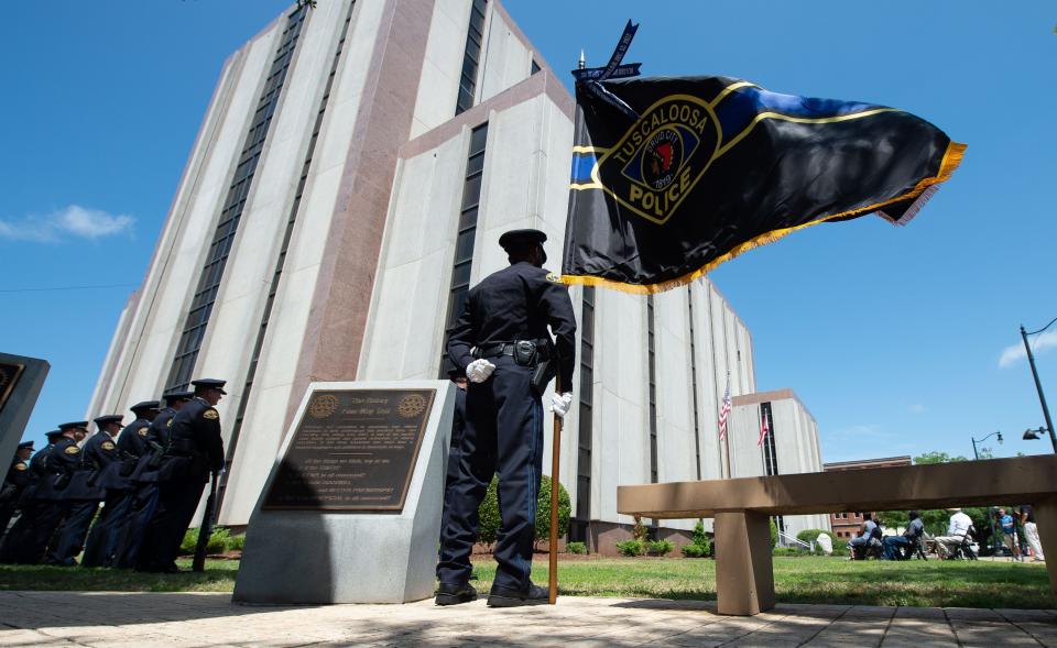 May 5, 2022; Tuscaloosa, AL, USA; West Alabama law enforcement officers memorialize fallen comrades through the history of Tuscaloosa County, and the cities of Northport and Tuscaloosa with a ceremony outside the Tuscaloosa County Courthouse Thursday. Tuscaloosa Police officer Qjuambi Walker holds the TPD flag. Mandatory Credit: Gary Cosby Jr.-The Tuscaloosa News