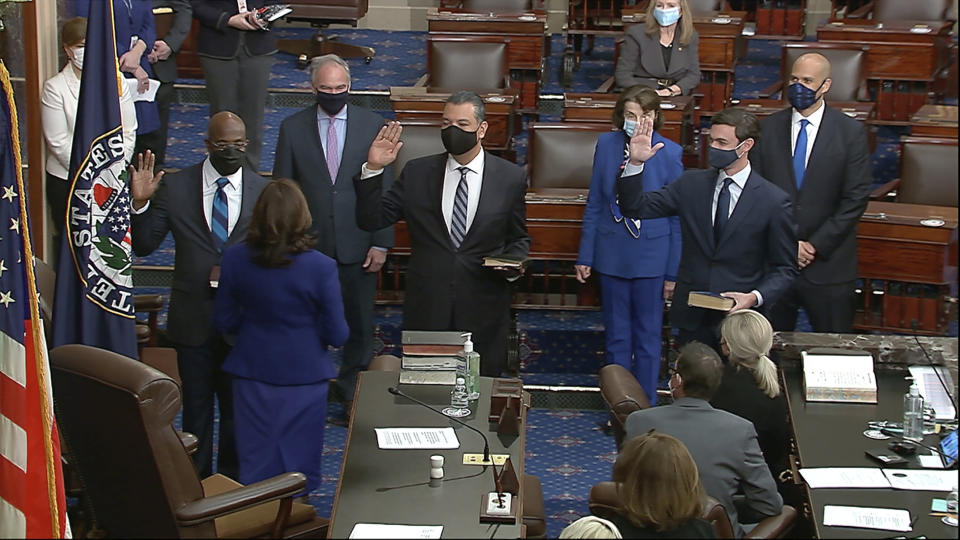 In this image from video, Vice President Kamala Harris swears in Sen. Raphael Warnock, D-Ga., Sen. Alex Padilla, D-Calif., and Sen. Jon Ossoff, D-Ga., on the floor of the Senate Wednesday, Jan. 6, 2021, on Capitol Hill in Washington. (Senate Television via AP)