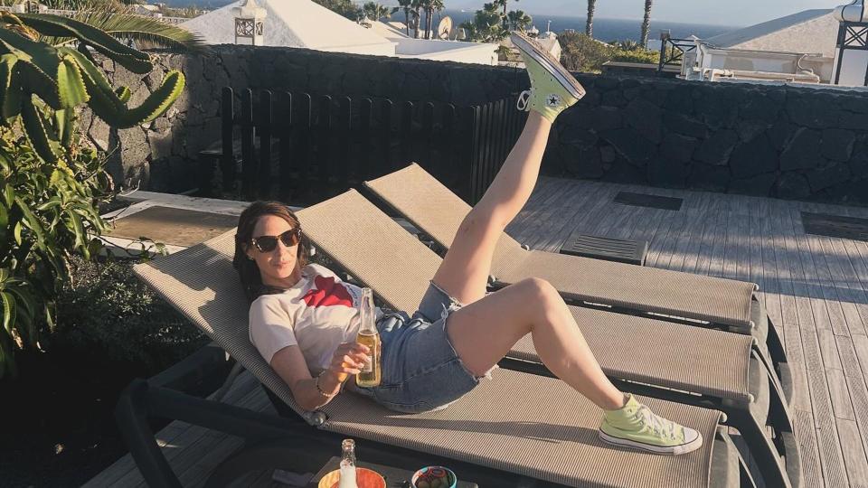 woman wearing denim shorts on sun lounger