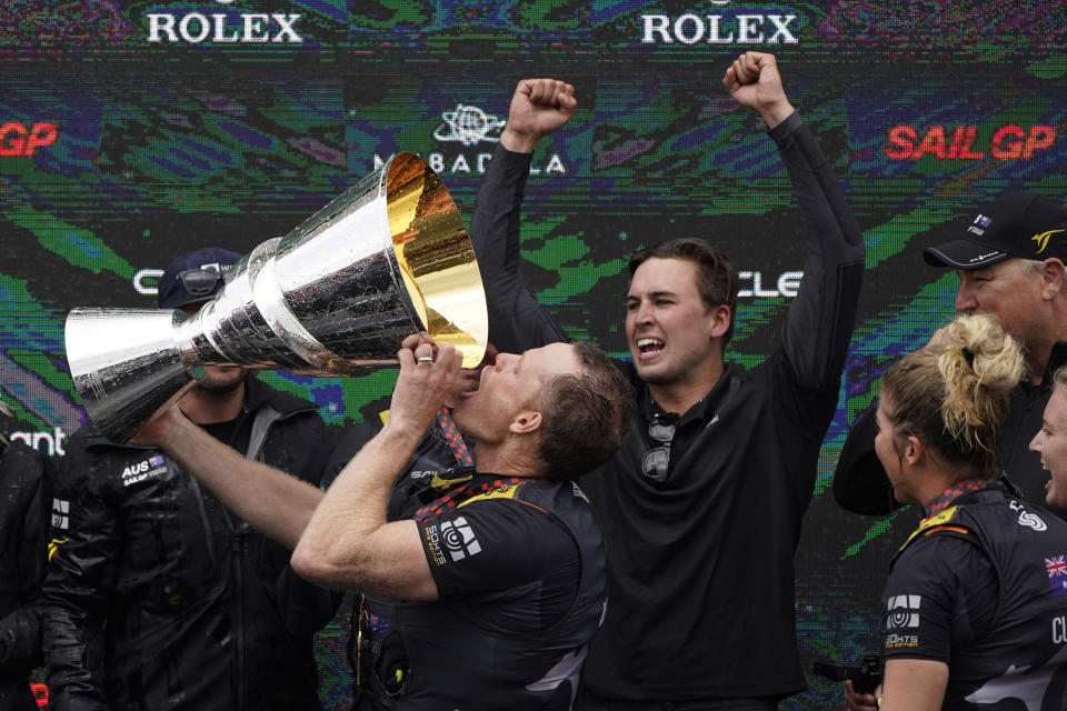 Australia SailGP grinder Sam Newton drinks from the trophy as the team celebrates after winning the $1 million, winner-take-all Season 2 finale of the Mubadala United States Sail Grand Prix, Sunday, March 27, 2022, in San Francisco. (AP Photo/Eric Risberg)