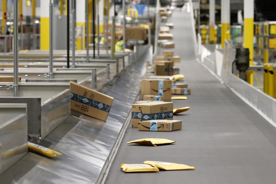 FILE - In this Dec. 17, 2019, file photo Amazon packages move along a conveyor at an Amazon warehouse facility in Goodyear, Ariz. In the years since Barack Obama and Joe Biden left the White House, the tech industry's political fortunes have flipped. Facebook, Google, Amazon and Apple have come under scrutiny from Congress, federal regulators, state attorneys general and European authorities. (AP Photo/Ross D. Franklin, File)