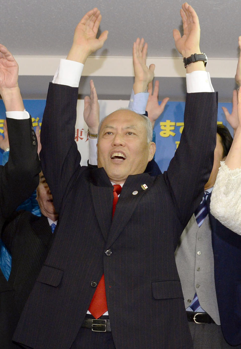 Former Health Minister Yoichi Masuzoe celebrates his gubernatorial election victory at his election office in Tokyo, Sunday, Feb. 9, 2014. Masuzoe, backed by Japan's ruling party, won Tokyo's gubernatorial election on Sunday, defeating two candidates who had promised to end nuclear power. (AP Photo/Kyodo News) JAPAN OUT, MANDATORY CREDIT