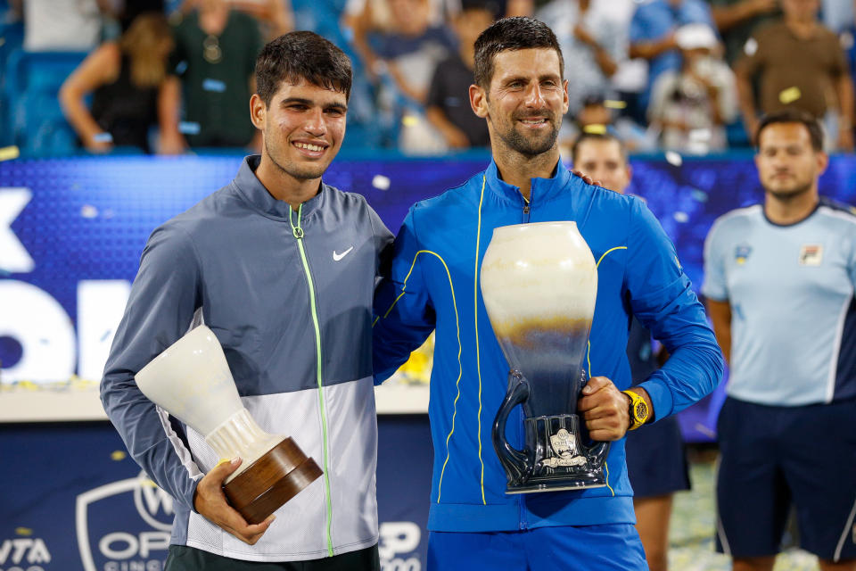 Carlos Alcaraz poses with Novak Djokovic.