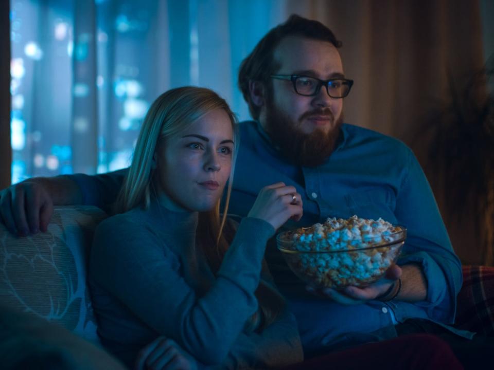 couple watching tv popcorn