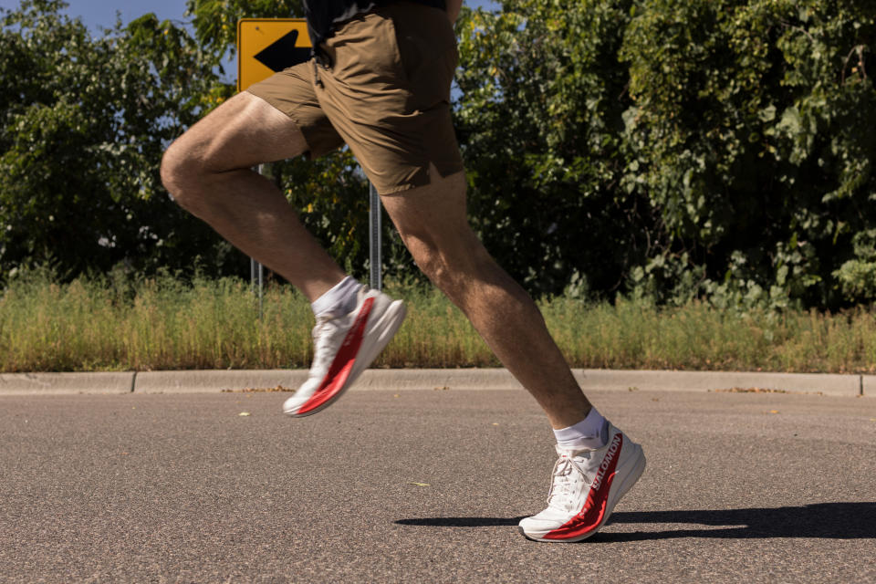 legs running in salomon phantom red and white shoes