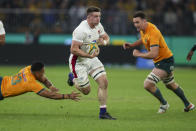 England's Tom Curry runs past the diving tackle of Australia's Len Ikitau, left, during the rugby international between England and the Wallabies in Perth, Australia, Saturday, July 2, 2022. (AP Photo/Gary Day)