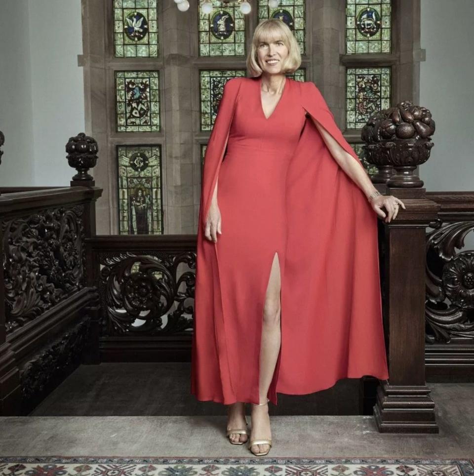 Ms Kane poses inside the castle wearing a red dress