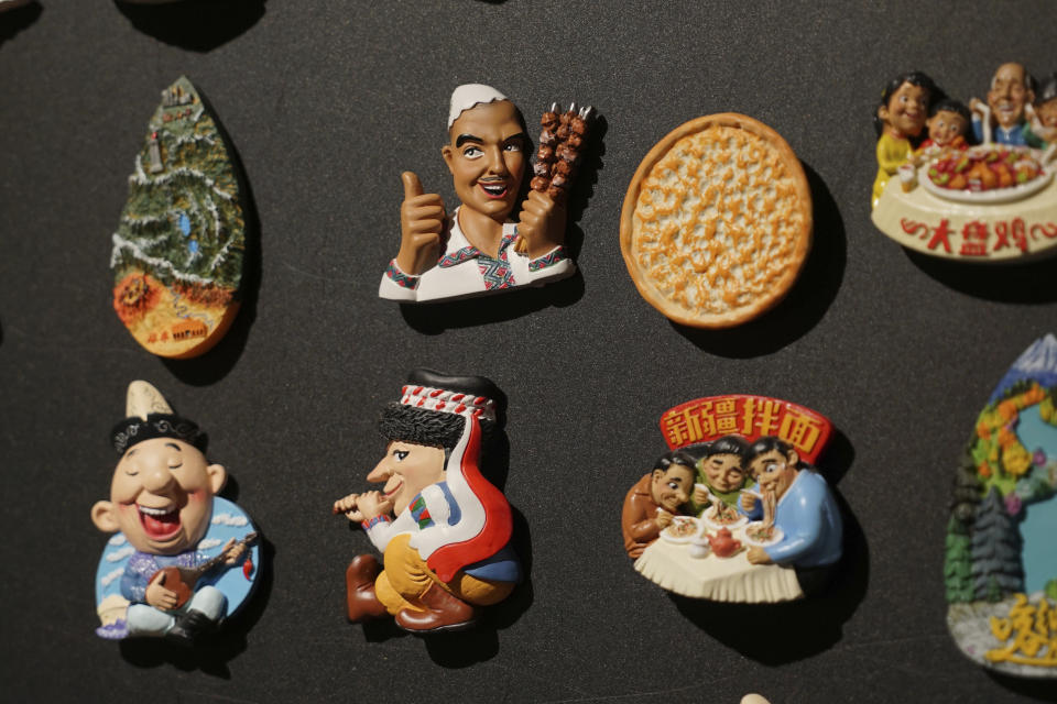 FILE - Uyghur-themed fridge magnets are displayed at a naan museum in Urumqi, the capital of China's far west Xinjiang region, on April 21, 2021. After a new U.N. report concluded that China's crackdown in its far-west Xinjiang region may constitute crimes against humanity, China is using a well-worn tactic to deflect criticism: blame a Western conspiracy. (AP Photo/Dake Kang, File)