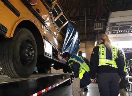 National Transportation Safety Board (NTSB) investigators view the wreck of a school bus in which several children were killed, at a depot in Chattanooga, Tennessee, U.S. November 22, 2016. NTSB/Handout via REUTERS