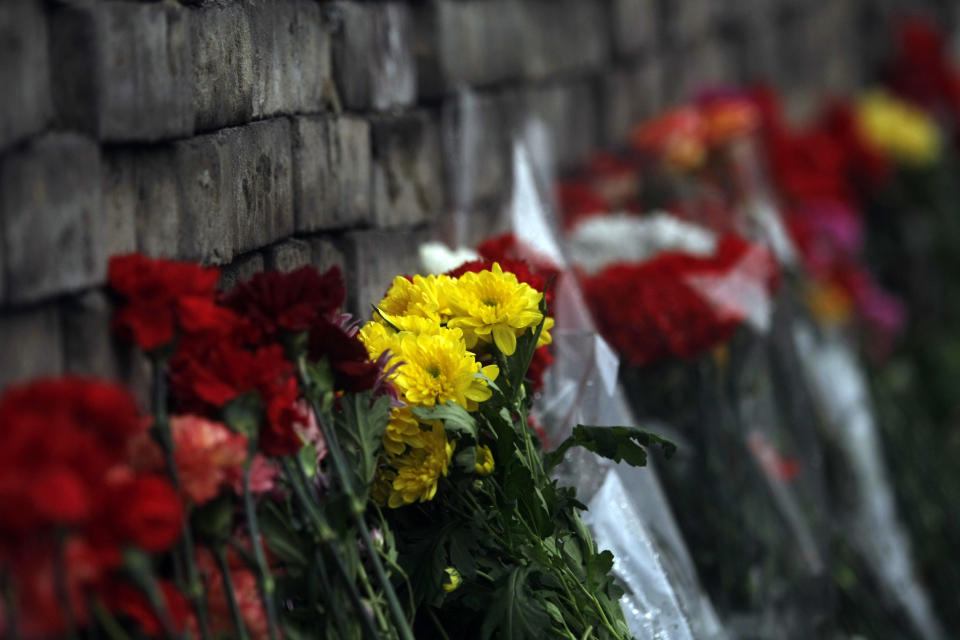 Flowers are laid at a memorial to protesters killed in clashes with the police at Independence Square in Kiev, Ukraine, Sunday, Feb. 23, 2014. The Kiev protest camp at the center of the anti-President Viktor Yanukovych movement filled with more and more dedicated demonstrators Sunday morning setting up new tents after a day that saw a stunning reversal of fortune in a political standoff that has left scores dead and worried the United States, Europe and Russia. (AP Photo/ Marko Drobnjakovic)