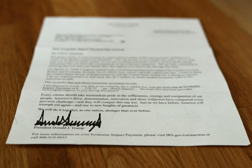 WASHINGTON, DC - APRIL 29: A letter bearing the signature of U.S. President Donald Trump was sent to people who received a coronavirus economic stimulus payment as part of the Cares Act April 29, 2020 in Washington, DC. The letter had a return address for the Internal Revenue Service in Austin, Texas, but was printed on White House letterhead. The initial 88 million payments totaling nearly $158 billion were sent by the Treasury Department last week as most of the country remains under stay-at-home orders due to the COVID-19 pandemic. (Photo by Chip Somodevilla/Getty Images)