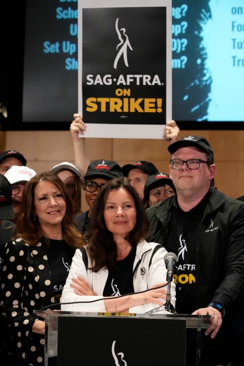 Joely Fisher, from left, SAG-AFTRA president Fran Drescher, and SAG-AFTRA National Executive Director and Chief Negotiator Duncan Crabtree-Ireland attend a press conference announcing a strike by The Screen Actors Guild-American Federation of Television and Radio Artists on Thursday, July, 13, 2023, in Los Angeles. This marks the first time since 1960 that actors and writers will picket film and television productions at the same time. (AP Photo/Chris Pizzello)