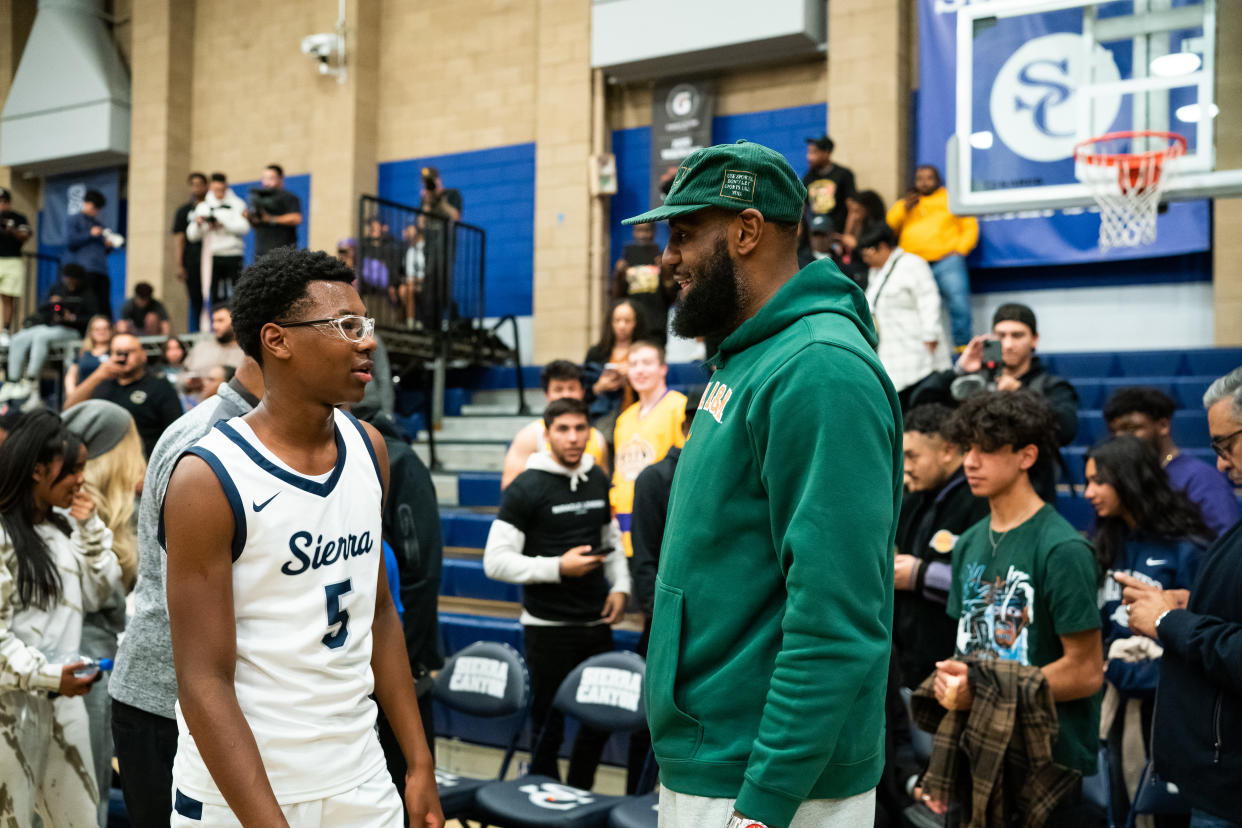 CHATSWORTH, CALIFORNIA - NOVEMBER 16: Bryce James talks to his dad, LeBron James, after the Sierra Canyon vs King Drew boys basketball game at Sierra Canyon High School on November 16, 2022 in Chatsworth, California. (Photo by Cassy Athena/Getty Images)