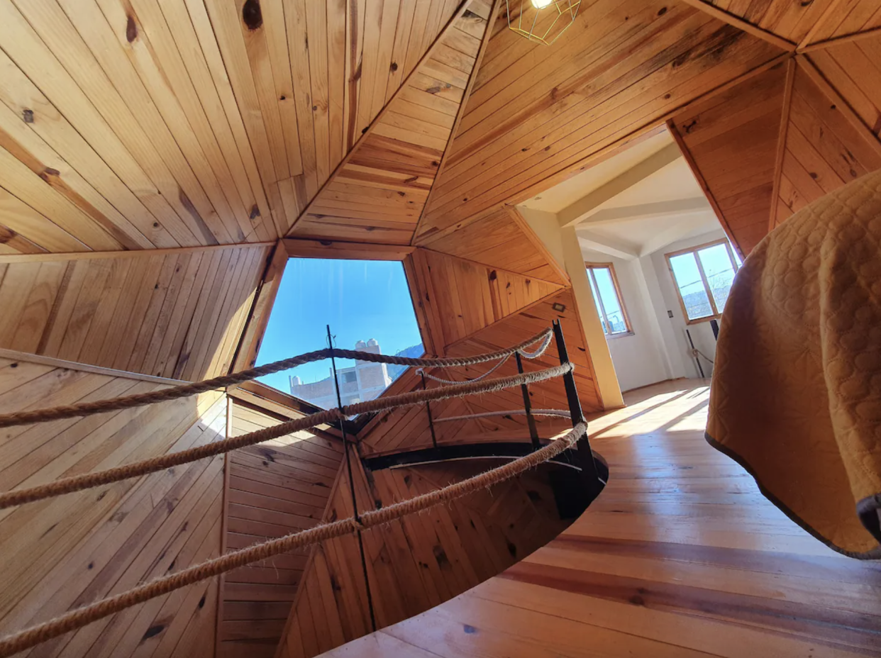 Chrysalis Dome Interior: woodwork and bed with rope railing