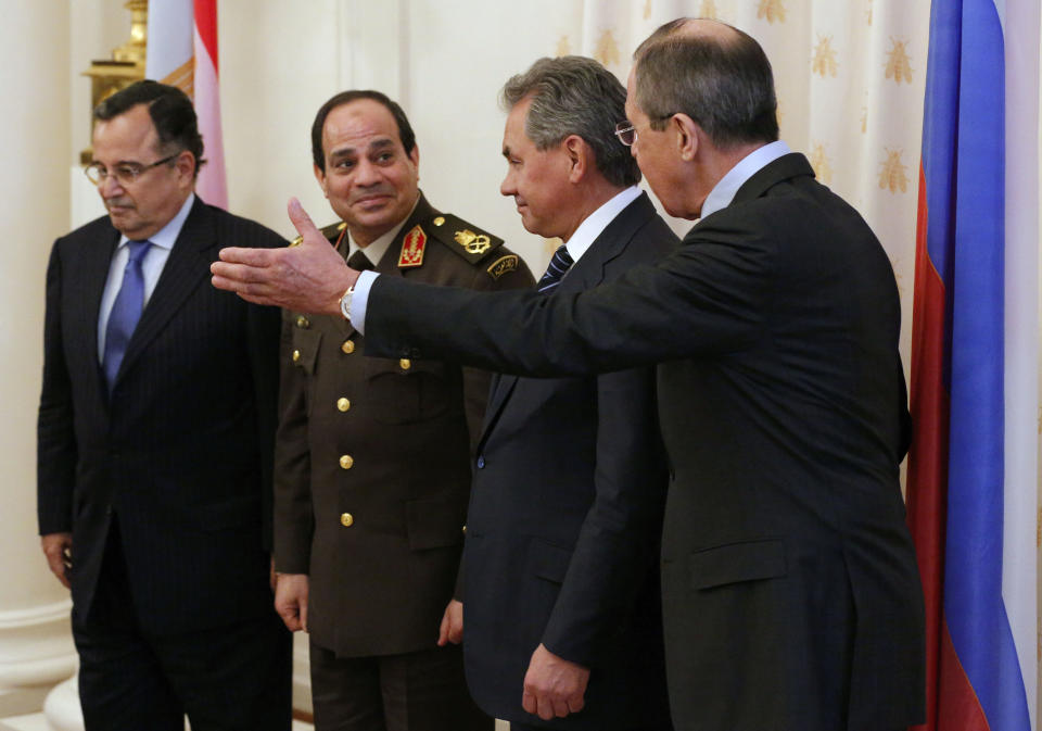 Russian Foreign Minister Sergey Lavrov, right, accompanied by Russian Defense Minister Sergei Shoigu, second right, shows the way for Egypt’s military chief Field Marshal Abdel-Fattah el-Sissi, second left, and Egyptian Foreign Minister Nabil Fahmy for their two-plus-two talks in Moscow, Russia, Thursday, Feb. 13, 2014. Egypt’s military chief visits Russia on his first trip abroad since ousting the Islamist president, part of a shift to reduce reliance on the United States at a time of frictions between the longtime allies. (AP Photo/Alexander Zemlianichenko)