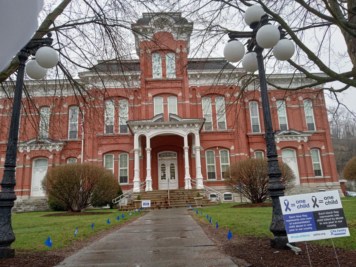 Blue flags in front of the Wayne County Courthouse in Honesdale number 24, one for every confirmed victim of child abuse reported to the Wayne County Children & Youth Services in 2022. They are in place during Child Abuse Prevention Month, April 2024. To report suspected child abuse, call ChildLine at 1-800-932-0313 or Wayne County Children & Youth Services at 570-253-5102.