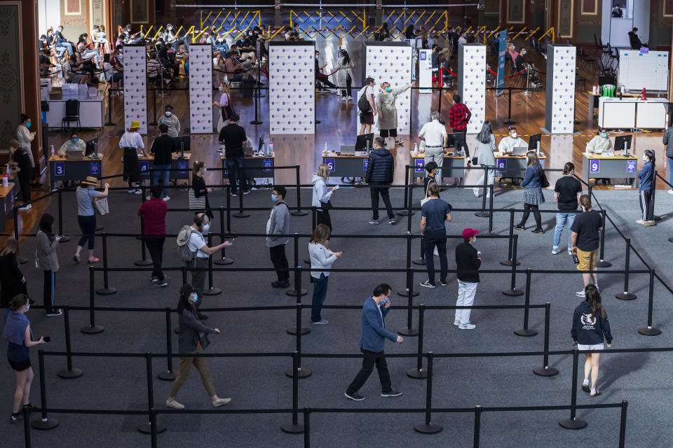 People queue up inside the Royal Exhibition Building COVID19 Vaccination Hub in Melbourne. Source: AAP