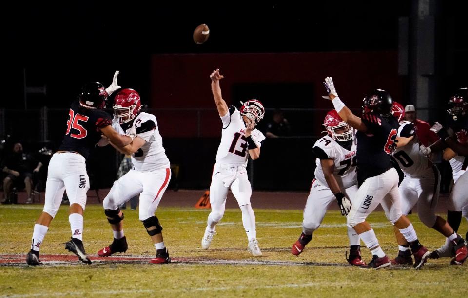 Nov 5, 2021; Peoria, Arizona, USA; Brophy Broncos quarterback Elijah Warner(13) throws a pass against the Liberty Lions at Liberty High School. Mandatory Credit: Rob Schumacher-Arizona Republic