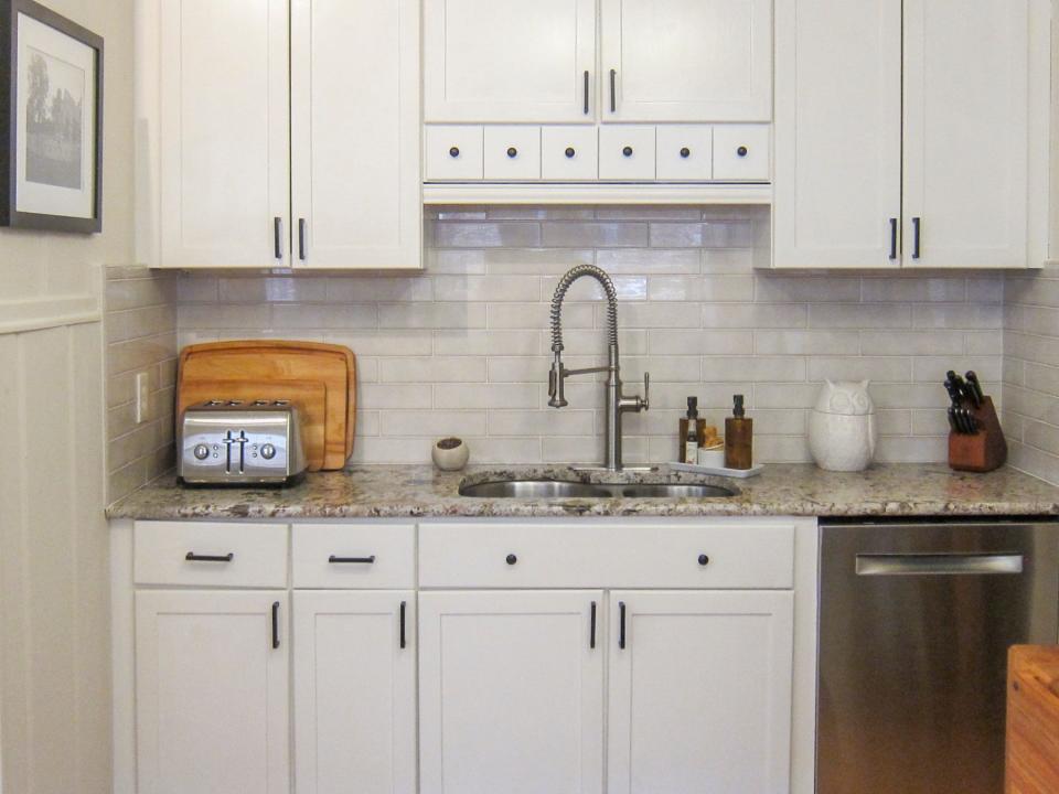 The couple added the white subway tile backsplash to this area of the kitchen.