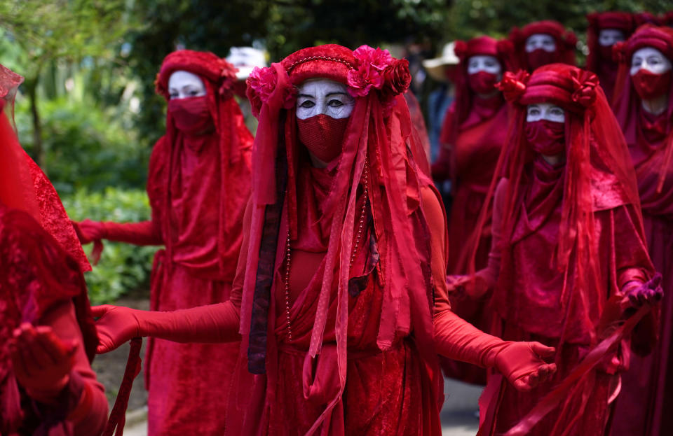 Activists in costume march during a demonstration around the meeting of the G7 in Falmouth, Cornwall, England, Saturday, June 12, 2021. Leaders of the G7 gather for a second day of meetings on Saturday, in which they will discuss COVID-19, climate, foreign policy and the economy. (AP Photo/Alberto Pezzali)