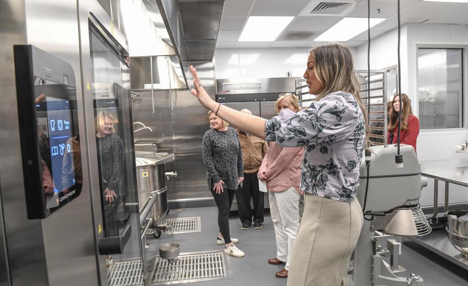Kitchen Manager Francesca Milford, left, shows one of the kitchen spaces during the grand opening ceremony for the City of Anderson's 110 North Kitchen + Commissary in Anderson, S.C. Thursday, February 29, 2024.