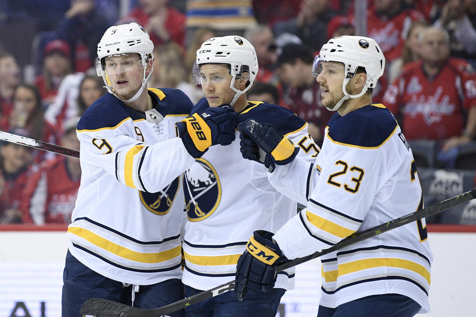 Buffalo Sabres center Jack Eichel (9) celebrates his goal with left wing Jeff Skinner, center, and center Sam Reinhart (23) during the first period of an NHL hockey game against the Washington Capitals, Saturday, Dec. 15, 2018, in Washington. (AP Photo/Nick Wass)