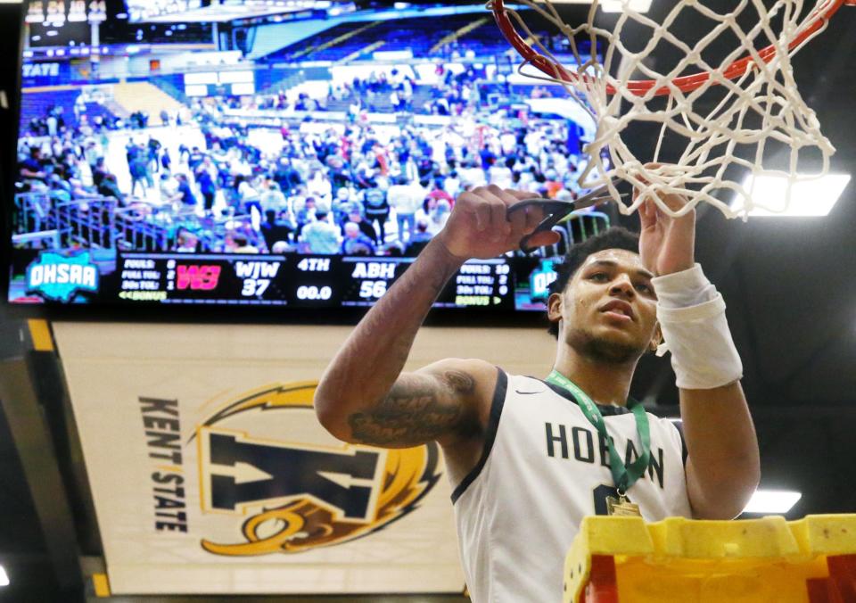 Hoban's Jonas Nichols takes first cut at the net after a win over Walsh Jesuit in the Division I regional final, Friday, March 10, 2023, at Kent State.