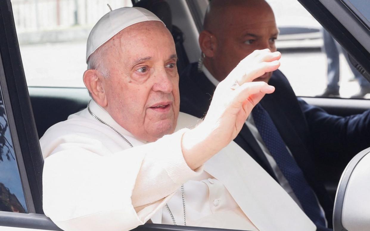 Pope Francis waves to well-wishers as he leaves Rome's Gemelli hospital - REMO CASILLI/REUTERS