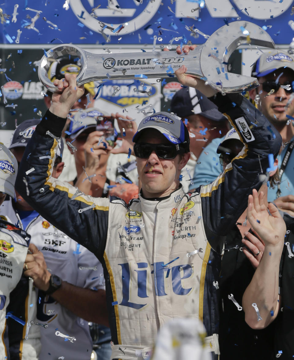 Brad Keselowski holds up the Kobalt 400 trophy after winning a NASCAR Sprint Cup Series auto race on Sunday, March 9, 2014, in Las Vegas. Keselowski overtook Dale Earnhardt Jr. on the last lap when Earnhardt ran out of fuel. (AP Photo/Julie Jacobson)