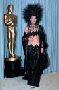 <p> Two questions: how is that skirt staying on and is that headpiece heavy? Cher wore this fortune-teller-esque outfit to the 1986 Academy Awards and it was just as memorable as you'd expect. </p>