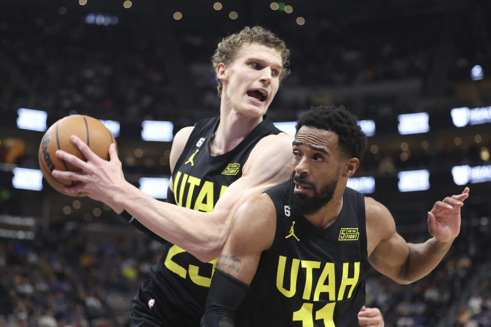 Utah Jazz forward Lauri Markkanen (23) and guard Mike Conley (11) battle for a rebound in an NBA basketball game against the Dallas Mavericks, Saturday, Jan. 28, 2023, in Salt Lake City. (AP Photo/Rob Gray)