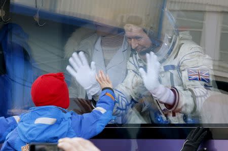 British astronaut Tim Peake, member of the main crew of the expedition to the International Space Station (ISS), waves to his children from a bus prior the launch of Soyuz TMA-19M space ship at the Russian leased Baikonur cosmodrome, Kazakhstan in this December 15, 2015 file photo. REUTERS/Dmitry Lovetsky/Pool