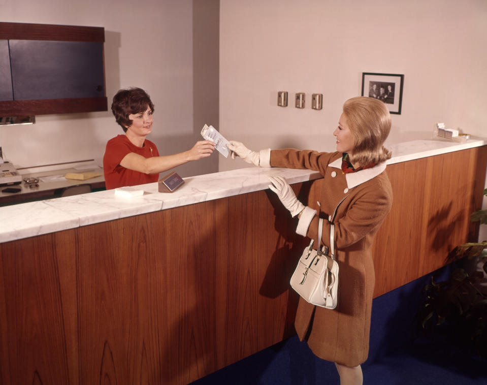 old photo of a bank teller and a customer