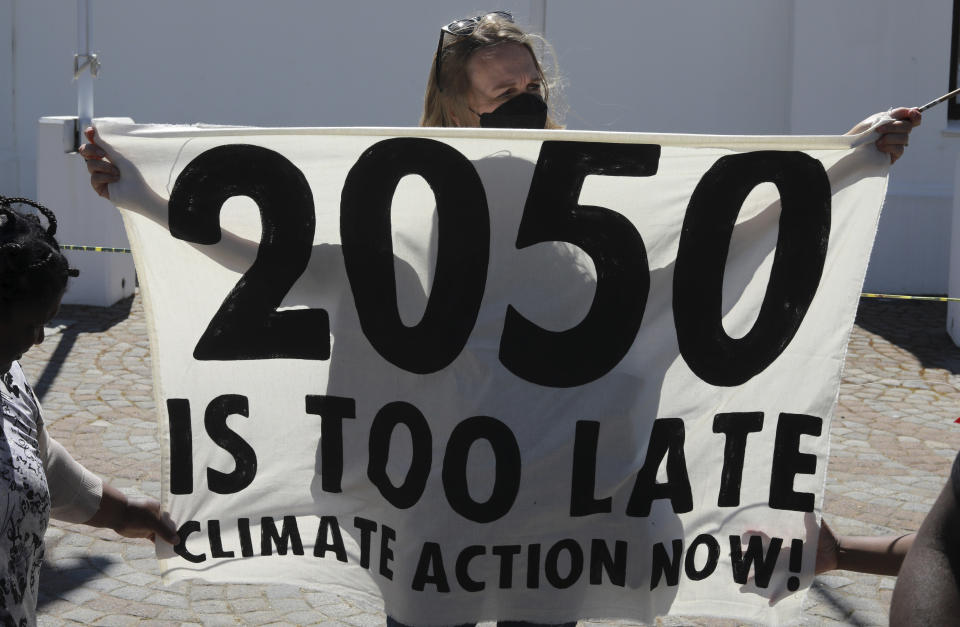 Activists protest for climate justice outside parliament in Cape Town, South Africa, Tuesday, Nov. 9, 2021. The protests coincides with the second week of as the COP26, UN Climate Summit in Glasgow. (AP Photo/Nardus Engelbrecht)
