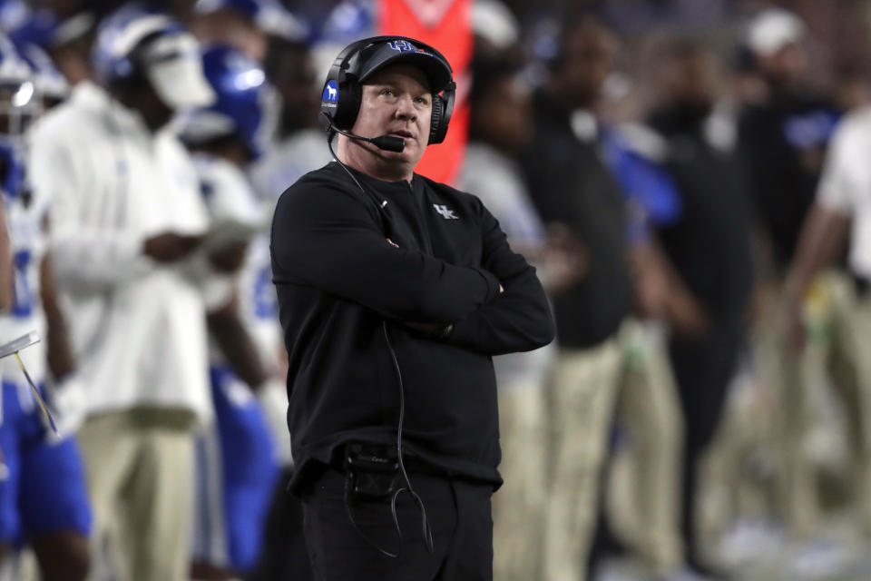 Kentucky head coach Mark Stoops checks the scoreboard during the first half of an NCAA college football game against South Carolina on Saturday, Nov. 18, 2023, in Columbia, S.C. (AP Photo/Artie Walker Jr.)