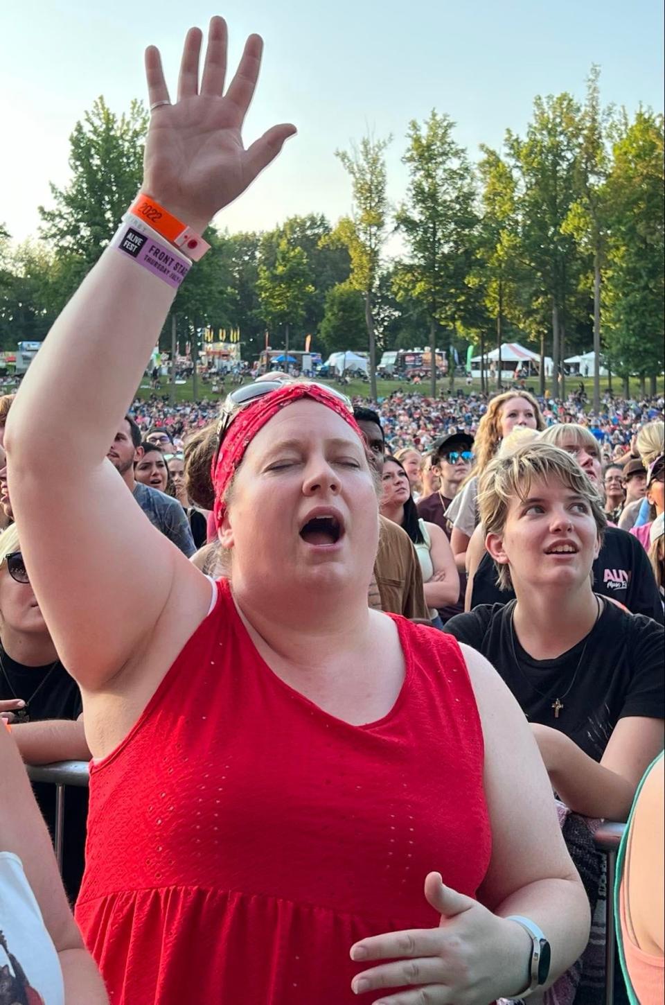 A fan expresses emotion Thursday during Danny Gokey's performance at the Alive Music Festival at Atwood Lake Park. Organizers expect 12,000 to 15,000 fans per night at the headlining concerts.