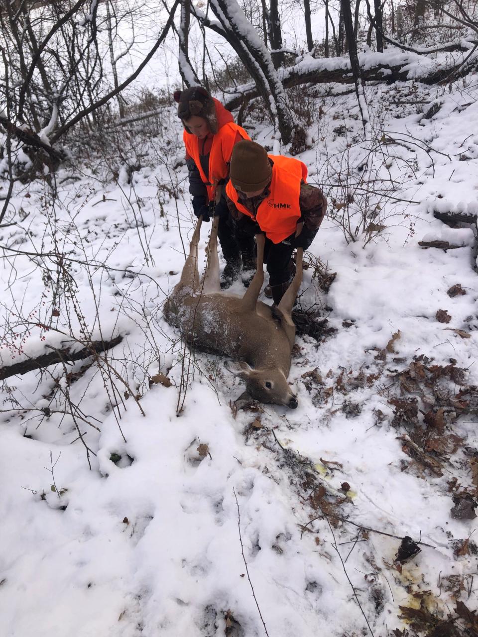 Roman and Paxton Wood dragging the first deer they saw harvested last year. The boys spotted the deer before their uncle, Brian Reisinger, and helped him find the doe and bring it home.