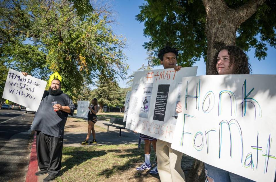Xavier Burks, 18, center, accompanied by girlfriend Mia Simonsen, 19, said he was coached by fired Sacramento High School boys basketball coach Matt Johnson since he was a youth basketball player at around 6 years old. They were protesting along with other supporters of Johnson outside the school Tuesday.