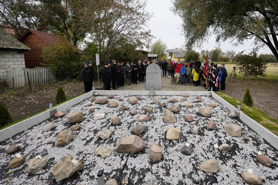 Jewish and Christian clergy stand together for prayers for the souls of some 60 Jews murdered by the occupying Nazi German forces during a ceremony marking a memorial to the victims in Wojslawice, Poland, Thursday Oct. 14, 2021. The grave is among many Holocaust graves that still exist across Poland today. In recent years they are being discovered, secured and marked. (AP Photo/Czarek Sokolowski)