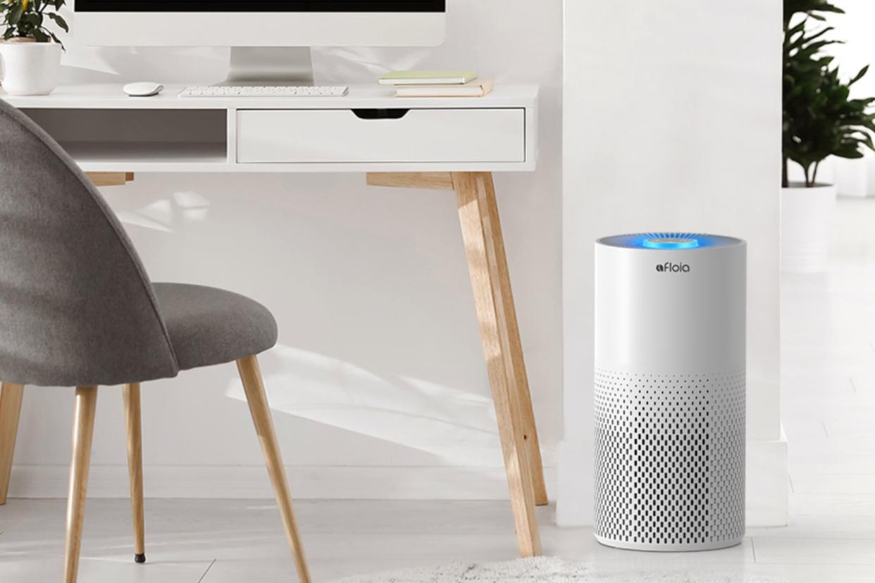 the Amazon air purifier on the ground beside a desk