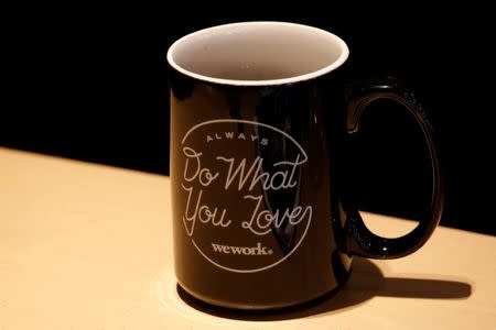 FILE PHOTO: A mug bears the name of WeWork is seen at its flagship location in Hong Kong, China February 23, 2017. REUTERS/Bobby Yip/File Photo