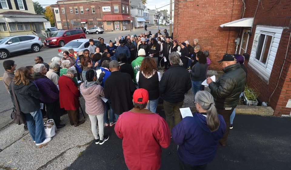 A crowd of about 100 people gather for the Take Back the Site vigil for homicide victim Calvin Isaiah outside a residence at 1061 E. 26th St. Isaiah, 24, was found dead inside his apartment at that residence in August 2018. Three men charged in connection with a crime spree that police say included Isaiah's killing are on trial in the case.