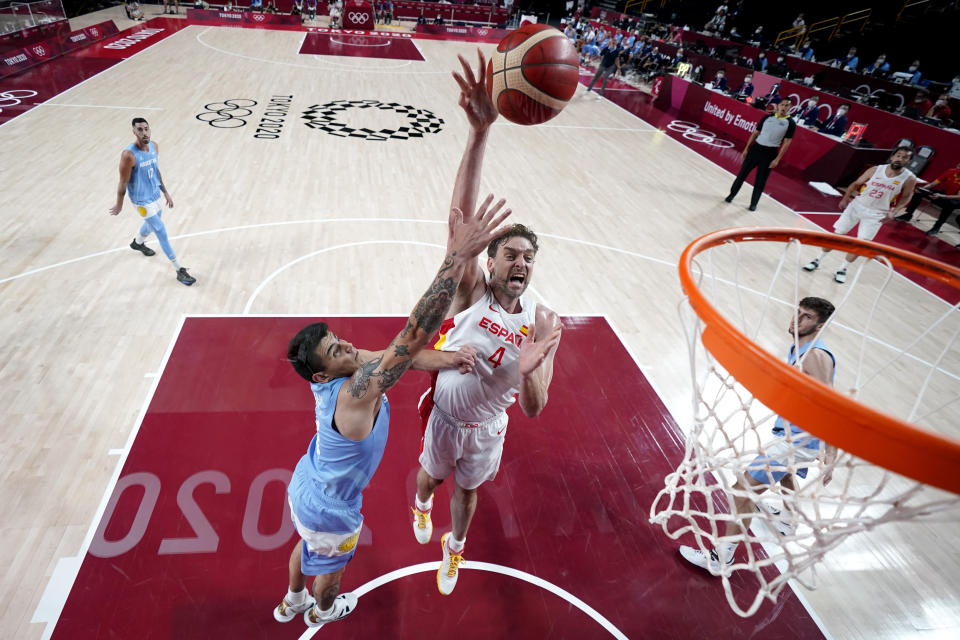 Spain's Pau Gasol (4) shoots over Argentina's Gabriel Deck (14) during a men's basketball preliminary round game at the 2020 Summer Olympics, Thursday, July 29, 2021, in Saitama, Japan. (AP Photo/Eric Gay)