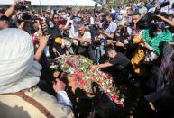 People gather at the burial site of former Algerian President Abdelaziz Bouteflika at El Alia cemetery, in Algiers