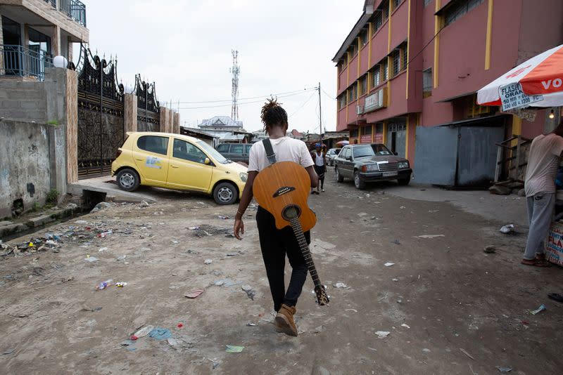 Congolese singer Celine Banza walks through her neighborhood in central Kinshasa